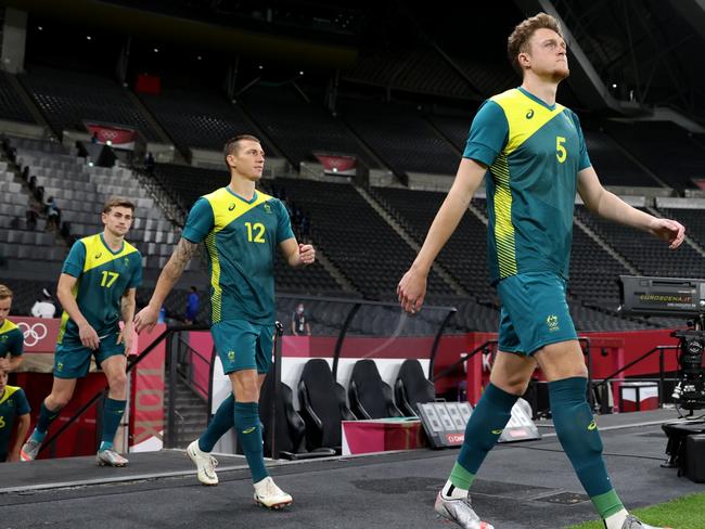 Harry Souttar (R), Mitch Duke (C) and Connor Metcalfe (L) take to the field prior to the Men's Football Group C match between Argentina and Australia at the Tokyo 2020 Olympic Games. (Photo by Masashi Hara/Getty Images)