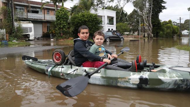 Local kids Farouk, 12 and his brother Ahmed, 4 took a kayak for a paddle up their street. Picture: David Swift