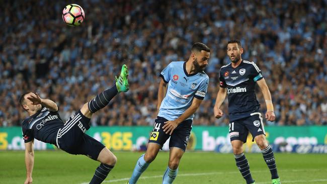 Leigh Broxham clears a ball away from Alex Brosque. Picture: Brett Costello