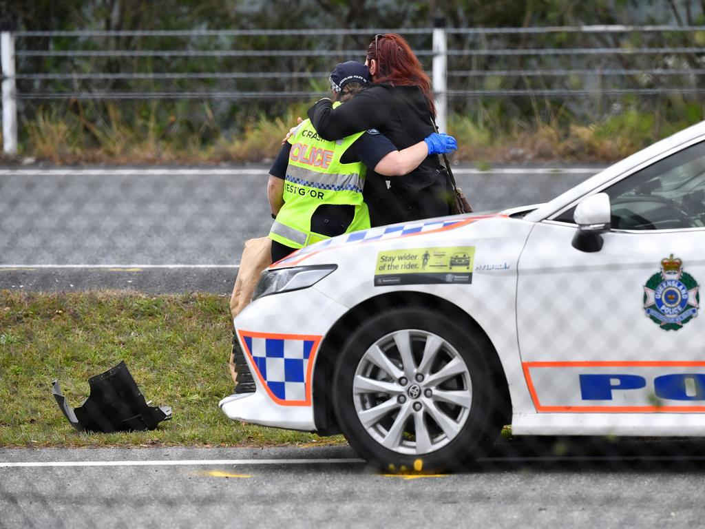 Queensland Police Officers are seen comforting each other at the scene where Senior Constable David Masters was killed. Picture: AAP