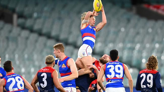 Cody Weightman climbs over the top of Max Gawn for a spectacular mark.