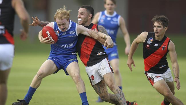 St Peter’s Nick McGill tries to break free from Tea Tree Gully's James Harley during an Adelaide Footy League match last year. Picture: AAP/Dean Martin