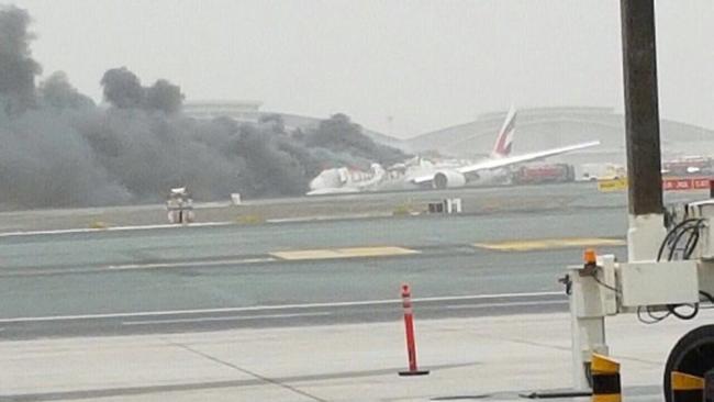 Smoke billows from the stricken Emirates plane after the emergency landing at Dubai International Airport. Picture: Twitter