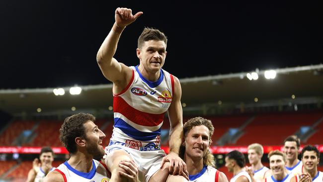 Taylor Duryea was chaired off Engie Stadium by Bulldogs teammates Marcus Bontempelli (left) and Aaron Naughton (right) after his 200th AFL game in May. Picture: Phil Hillyard