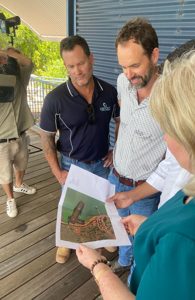 Representatives from Ostojic, SMC Marine and the Territory government inspect rough plans for Mandorah jetty.