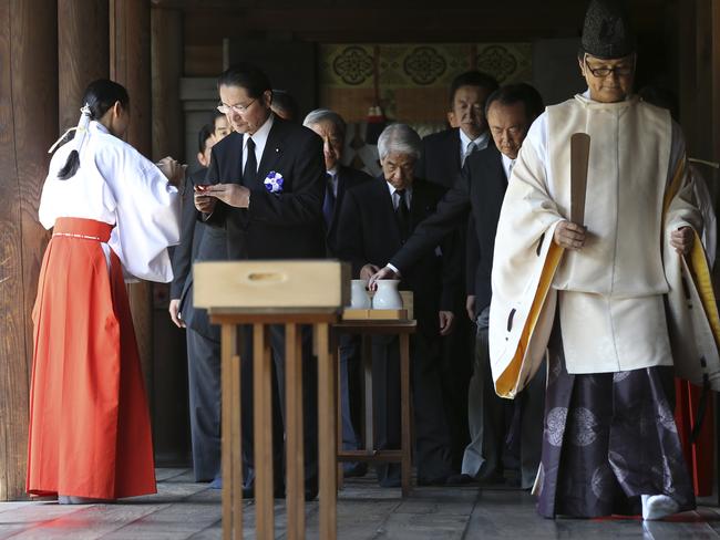 Historic site ... a group of Japanese politicians prepare to sip a cup of rice wine after paying respects to the war dead at Yasukuni Shrine in Tokyo. Picture: AP/Eugene Hoshiko