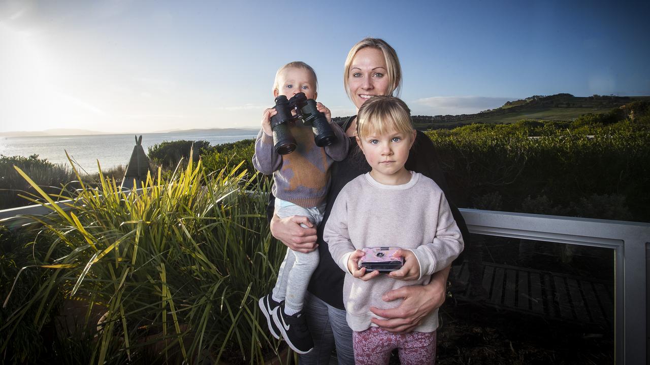 Cremorne resident Bec Hill with son Ziggy Polanowski and daughter Ivy Polanowski on the balcony of their home overlooking the beach. Picture: LUKE BOWDEN