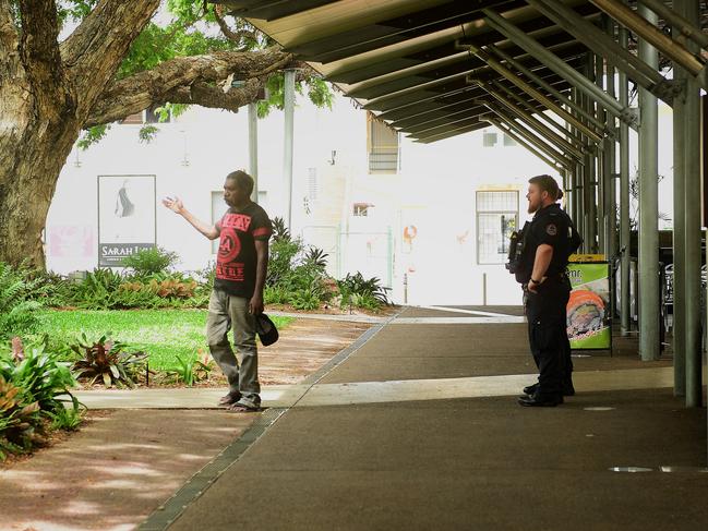 Police remove an itinerant sleeping in front of a storefront on the Smith street mall. Picture: Justin Kennedy