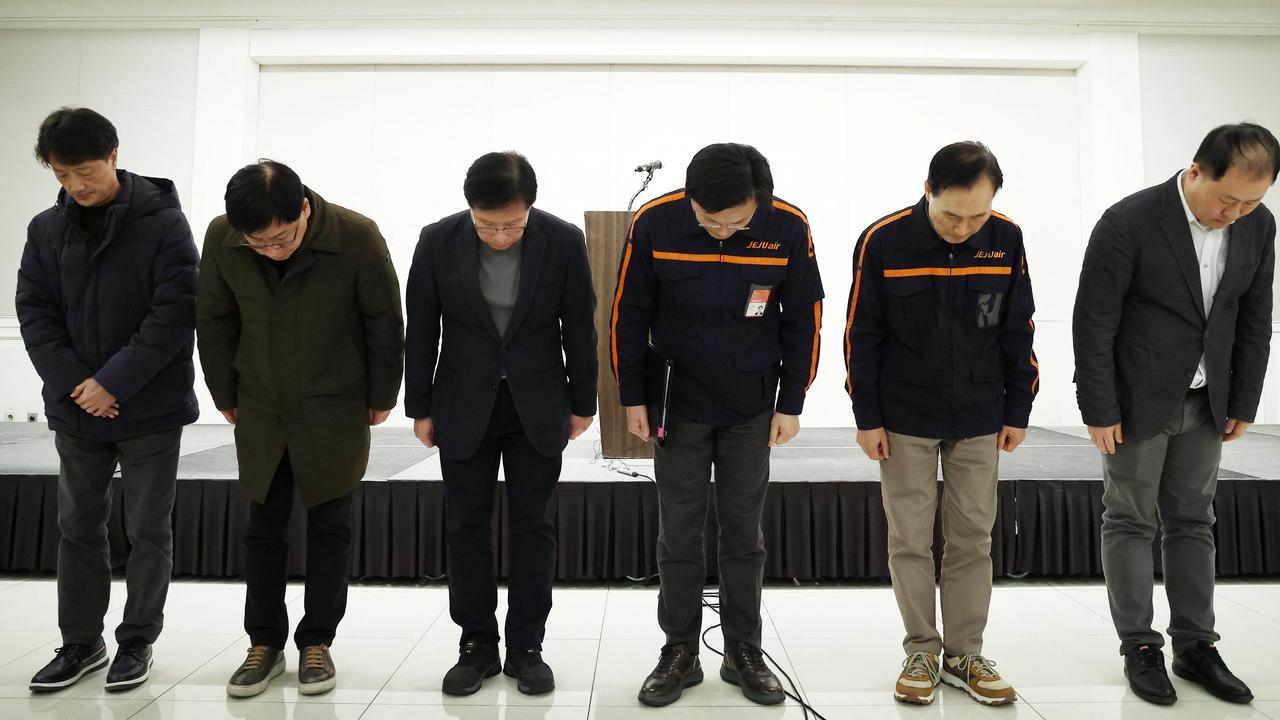 Jeju Air chief executive Kim E-bae (3rd-R) and other executive members bow in apology ahead of the briefing in Seoul. Picture: Yonhap/AFP