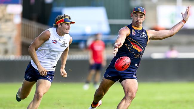 Taylor Walker of the Crows passes watched  by Josh Worrell  of the Crows  during an open training session at Norwood Oval on the Parade ,Norwood.Friday,January,17,2025.Picture Mark Brake