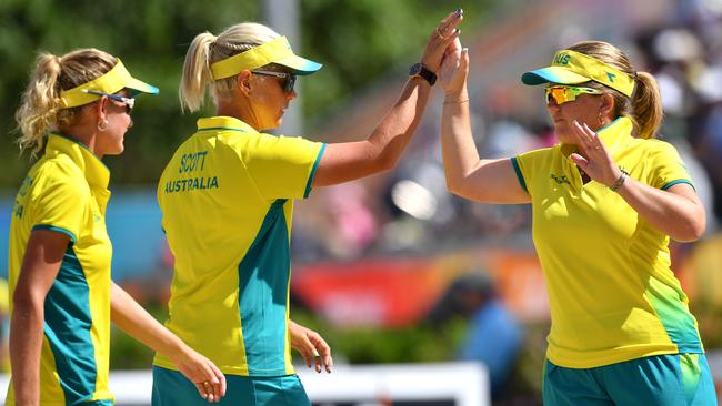 Rebecca van Asch, right, congratulates teammates Natasha Scott, centre, and Carla Krizanic as they make their way to another Commonwealth Games gold medal. Picture: AAP/Darren England