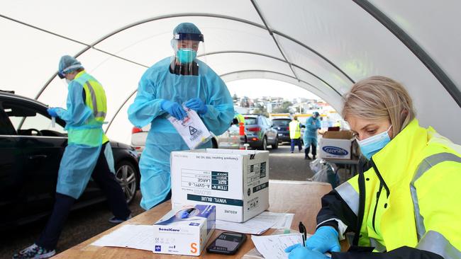 Registered Nurse Kahala Dixon processes COVID-19 swab tests at Bondi Beach. Picture: Getty