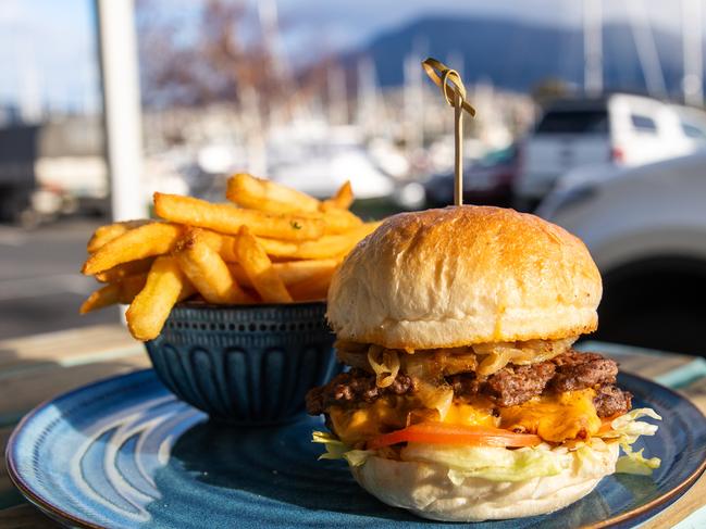 One of Marina Cafe’s tasty burgers, served with a side of chips, which is a veritable tower of burgery goodness. Picture: Linda Higginson