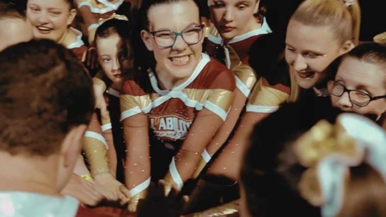Brooke Ridgway, who was born with disabilities and has recently been diagnosed with Hodgkin's lymphoma, with her cheerleading team. Picture: Supplied