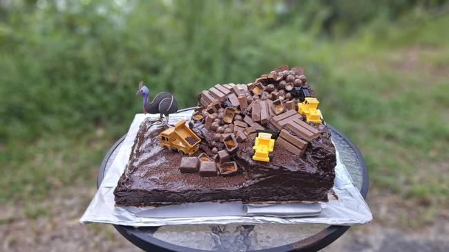 Cape Tribulation locals and road works employees have celebrated the 'first birthday' of a landslide with a mud cake after the remote town was left isolated, following torrential rain and flooding after Cyclone Jasper in 2023. Photo: Supplied.