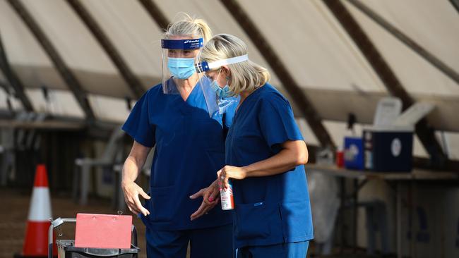 Nurses are seen setting up at sunrise on New Years Day at the Covid-19 drive thru testing site at Bondi Beach. Picture: Newscorp Daily Telegraph / Gaye Gerard