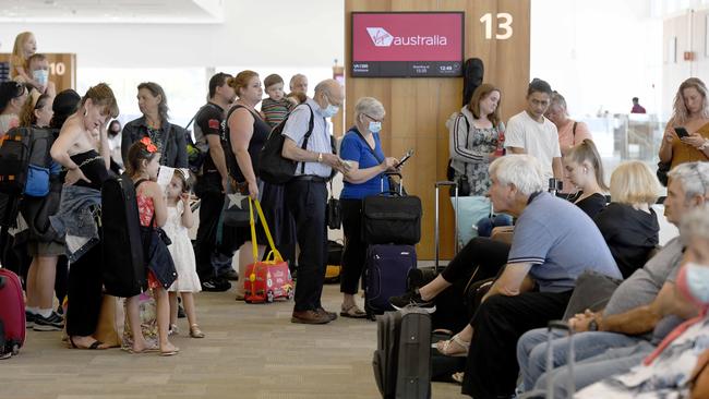 Passengers wait to board a plane to Brisbane at Adelaide Airport after the announcement that the city is going into a three day lockdown. Picture: Naomi Jellicoe