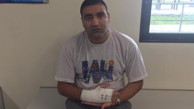 Ali Yousuf nursing his broken hand, which he says happened after he was set upon by up to 13 guards. Picture: Supplied