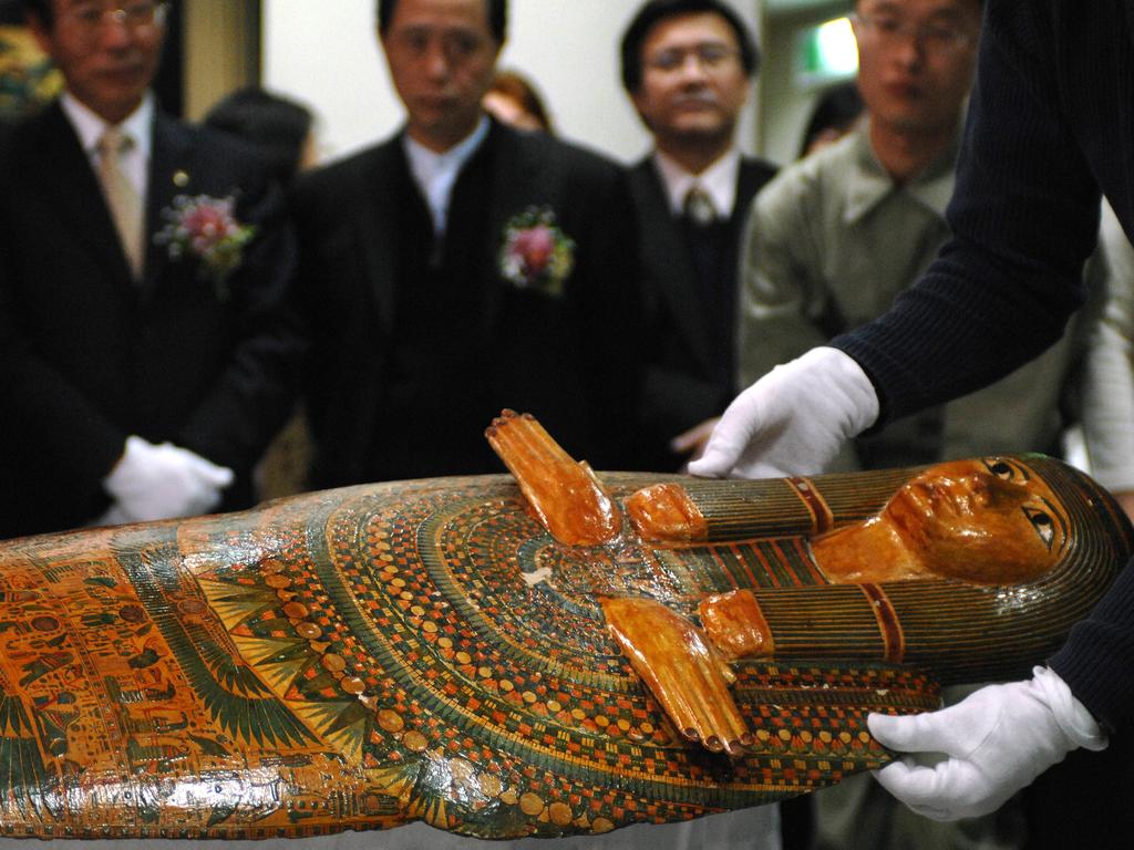 A worker displays the 'Unlucky Mummy', from 945 BC, displayed by the British Museum during a press conference at Taiwan's National Palace Museum in Taipei 24 January 2007. According to the British museum, the 'Unlucky Mummy' is not a mummy at all, but rather a gessoed and painted wooden 'mummy-board' or inner coffin lid, found at Thebes. It is referred to as the 'Unlucky Mummy' as it has acquired a reputation for bringing misfortune. Some 271 pieces of antiques from the British Museum will be exhibited at Taiwan's National Palace Museum betwen 04 Febuary to 27 May 2007. AFP PHOTO/Sam YEH