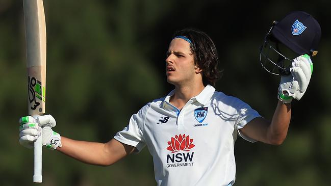 SYDNEY, AUSTRALIA - OCTOBER 10: Sam Konstas of the Blues raises his bat in the air after hitting a six to reach his century during the Sheffield Shield match between New South Wales and South Australia at Cricket Central, on October 10, 2024, in Sydney, Australia. (Photo by Mark Evans/Getty Images)