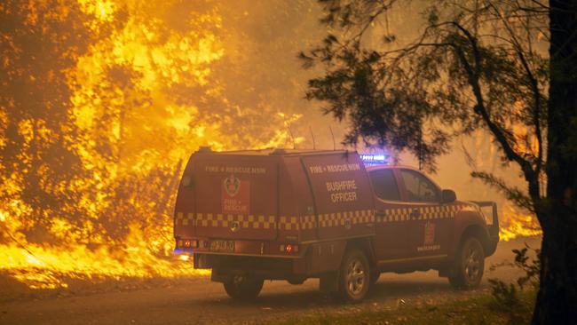 RFS Firefighters desperately worked to save a home on Willinga Drive at Bawley Point on Thursday. Picture Gary Ramage