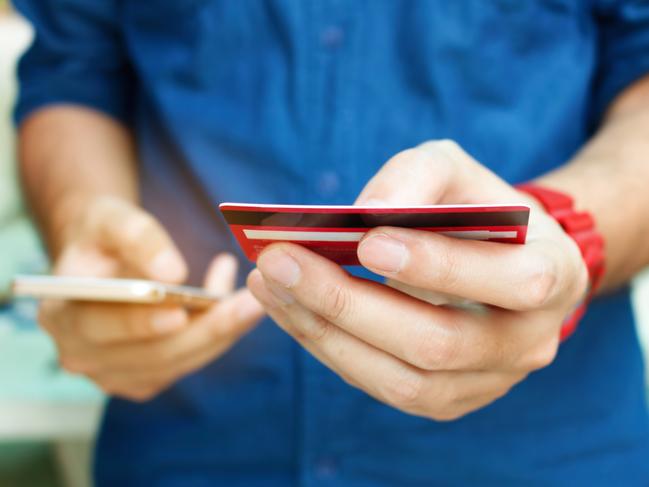 A man using a credit card online while shopping on his smartphone. Picture: iStock.