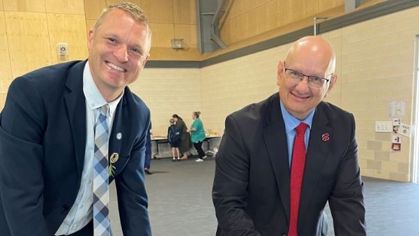 Ripley Valley State Secondary College principal, Brendan Krueger and Blair MP Shayne Neumann inspect the plans for the school's memorial.