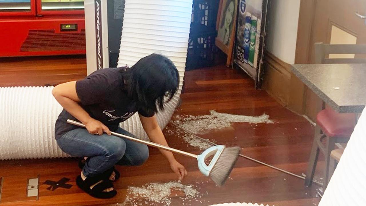 Gawler Heritage Cafe owner Marie-Anne San Gabriel cleaning up broken glass after being targeted in a crime spree in January, 2024. Picture: George Yankovich
