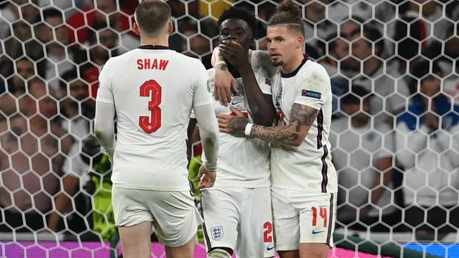 England's midfielder Bukayo Saka (C) is comforted after his miss in the Euro 2020 final.