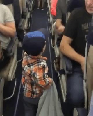 Video: Adorable kid fist pumps passengers on flight