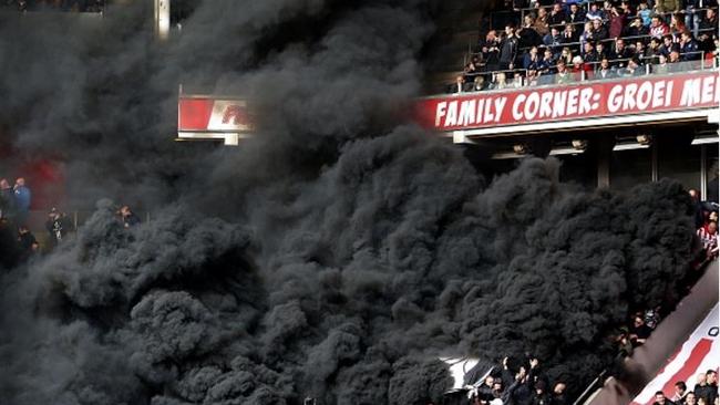 PSV fans let off smoke bombs against Ajax.