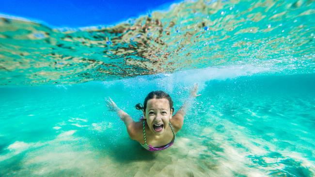 Zoe Bisschop, 9, enjoys the warm water at Kirra beach. Picture: NIGEL HALLETT