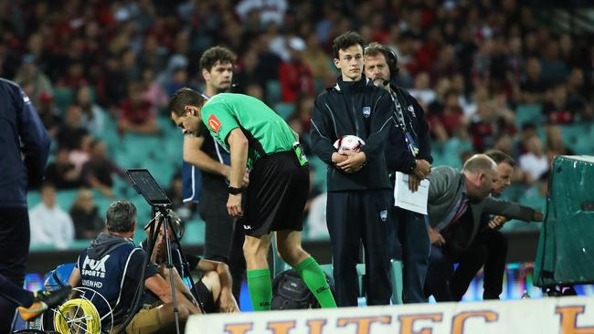 Referee Chris Beath checks a VAR goal review. Picture. Phil Hillyard