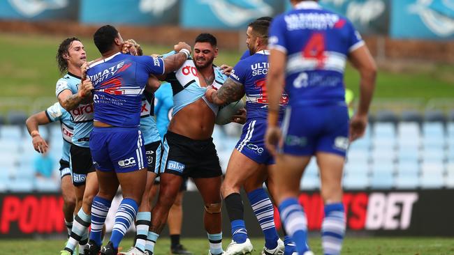 Royce Hunt of the Sharks and Tevita Pangai Junior of the Bulldogs tussle. Photo by Mark Metcalfe/Getty Images