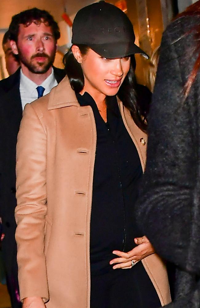 Meghan Markle cradled her bump as she left the venue. Picture: Skyler2018/Backgrid