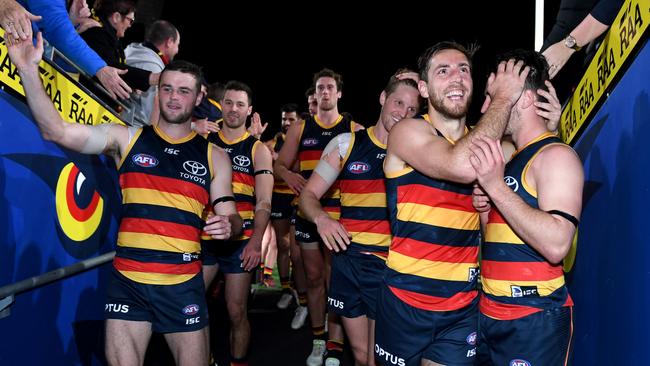 Richard Douglas of the Crows hugs Lachlan Murphy as they head down the race after the win over the Saints. Picture: Mark Brake/Getty Images