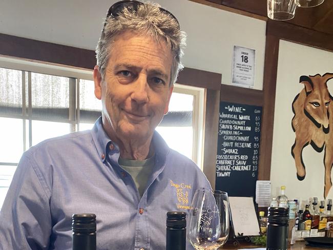 Dingo Creek Vineyard owner Doug Tritton samples some of his winery's products.