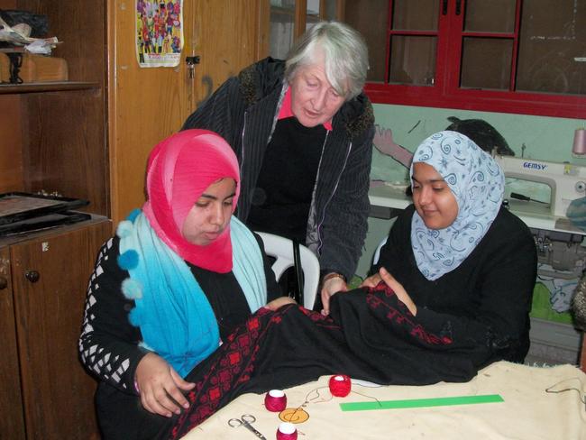 Photo 2: Dr Jean Calder AC with young women completing vocational training in embroidery.