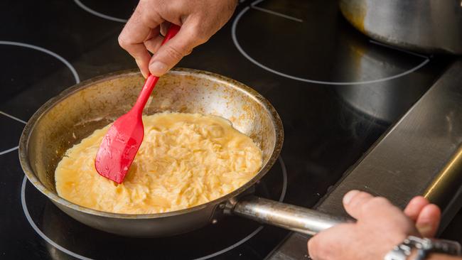 Continually stir the eggs like you would scrambled eggs, to cook evenly and withougt colouring. Once the eggs are halfway cooked, stop to let the omelette form.