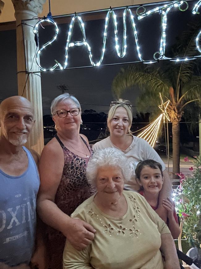 Frank and Amanda Dimech, Josephine Dimech (sitting) and Chantelle and Cohen Smith keep the Christmas lights tradition alive on Cumberland Rd.