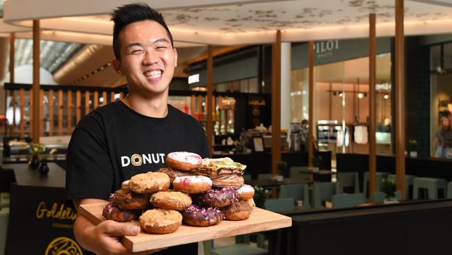 Owner Phillip Kouch with some of the sweet offerings from Goldeluck’s Bakeshop.