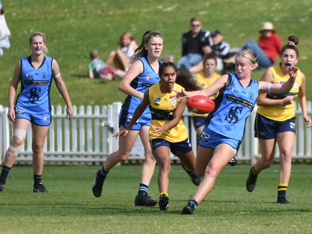 Sturt SANFLW player Georgia Swan with the ball, being chased by Woodville-West Torrens' Tesharne Maher and Tess Grant. Picture: Peter Swan