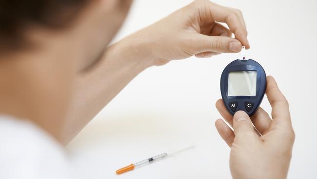 A diabetic checks their blood sugar.