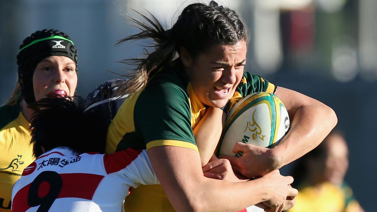 Millie Boyle of the Wallaroos is tackled by the Japan defence in Newcastle.