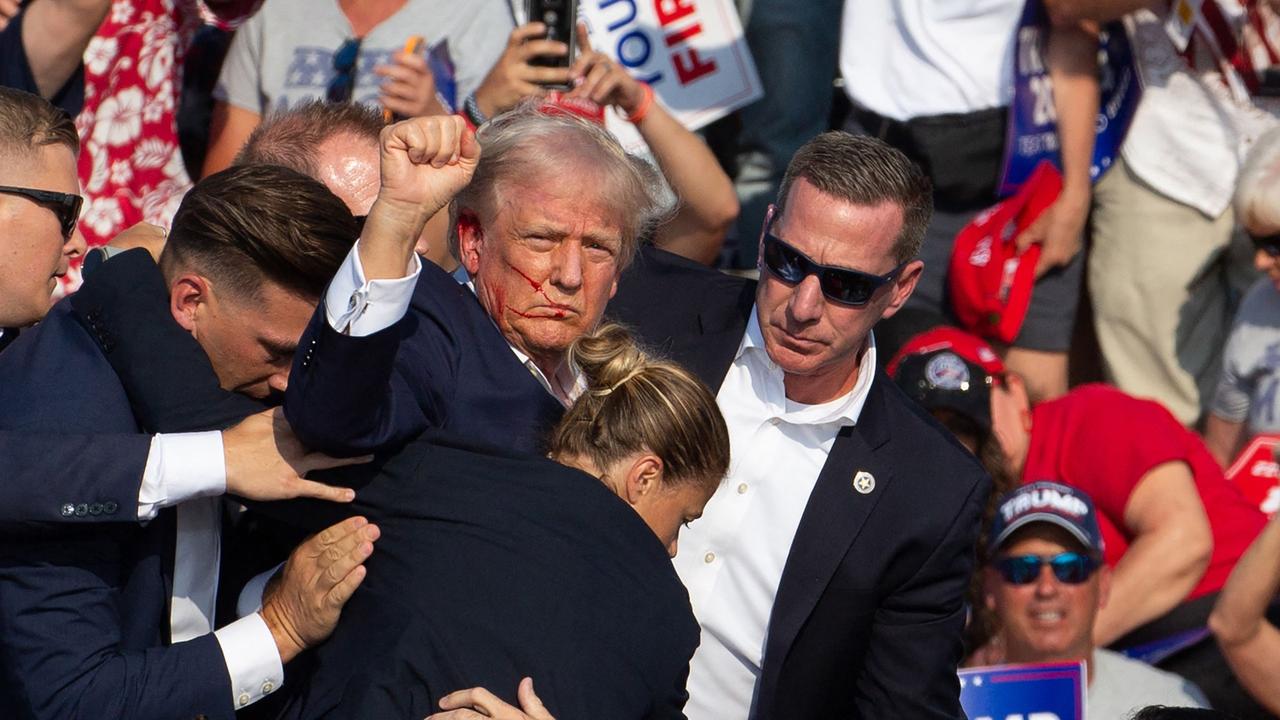 Trump was seen with blood on his face following the shooting. Picture: Rebecca DROKE / AFP