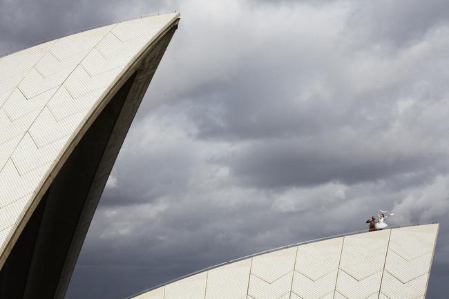 Dancers Amber Scott and Patrick Thaiday atop the sails of the Opera House as the Australian Ballet heralds its 50th anniversary year. Picture: Jess Bialek