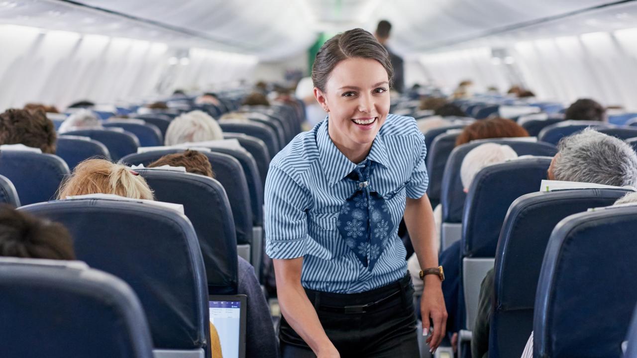 A flight attendant warns passengers away from drinking coffee and tea prepared on board the aircraft. Picture: Getty Images