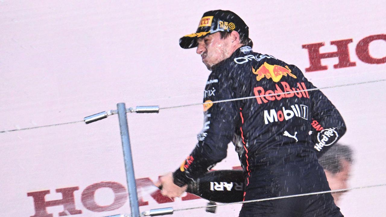 Red Bull Racing's Dutch driver Max Verstappen sprays champagne on the podium