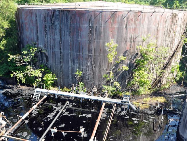 A pond of oil sits around massive tanks at the Panguna mine in Bougainville, Thursday, May 20, 2010. Rebels shut down the mine due to environmental concerns but now, some 20 years on, an oil slick seeping towards the Bougainville coast and dumped chemicals is the latest environmental disaster for the tiny Papua New Guinean island. (AAP Image/Ilya Gridneff) NO ARCHIVING