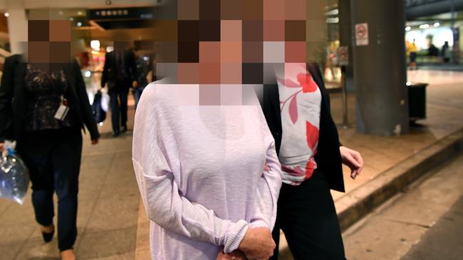 Betty Colt is escorted by police at Sydney Airport on April 6, 2018 after her arrest in South Australia. Picture: Joel Carrett.
